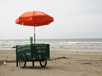 This photo depicts the epitome of what small businesses are all about ... finding a consumer need and filling it.  Here we have a vendor selling cold beer, water, and coconut ice cream on the beach.  Nothing fancy ... just getting the job done!  Photo by Felipe Skroski of Curitiba, Brazil.